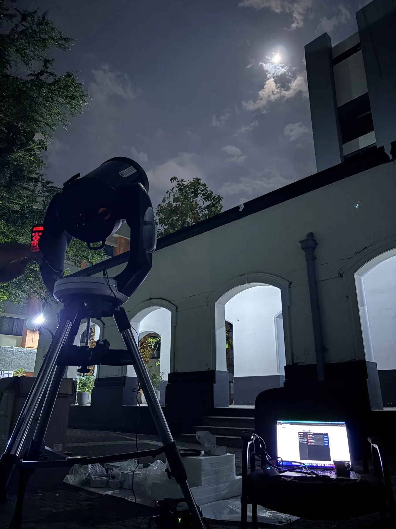 A telescope and computer operating during a night observation