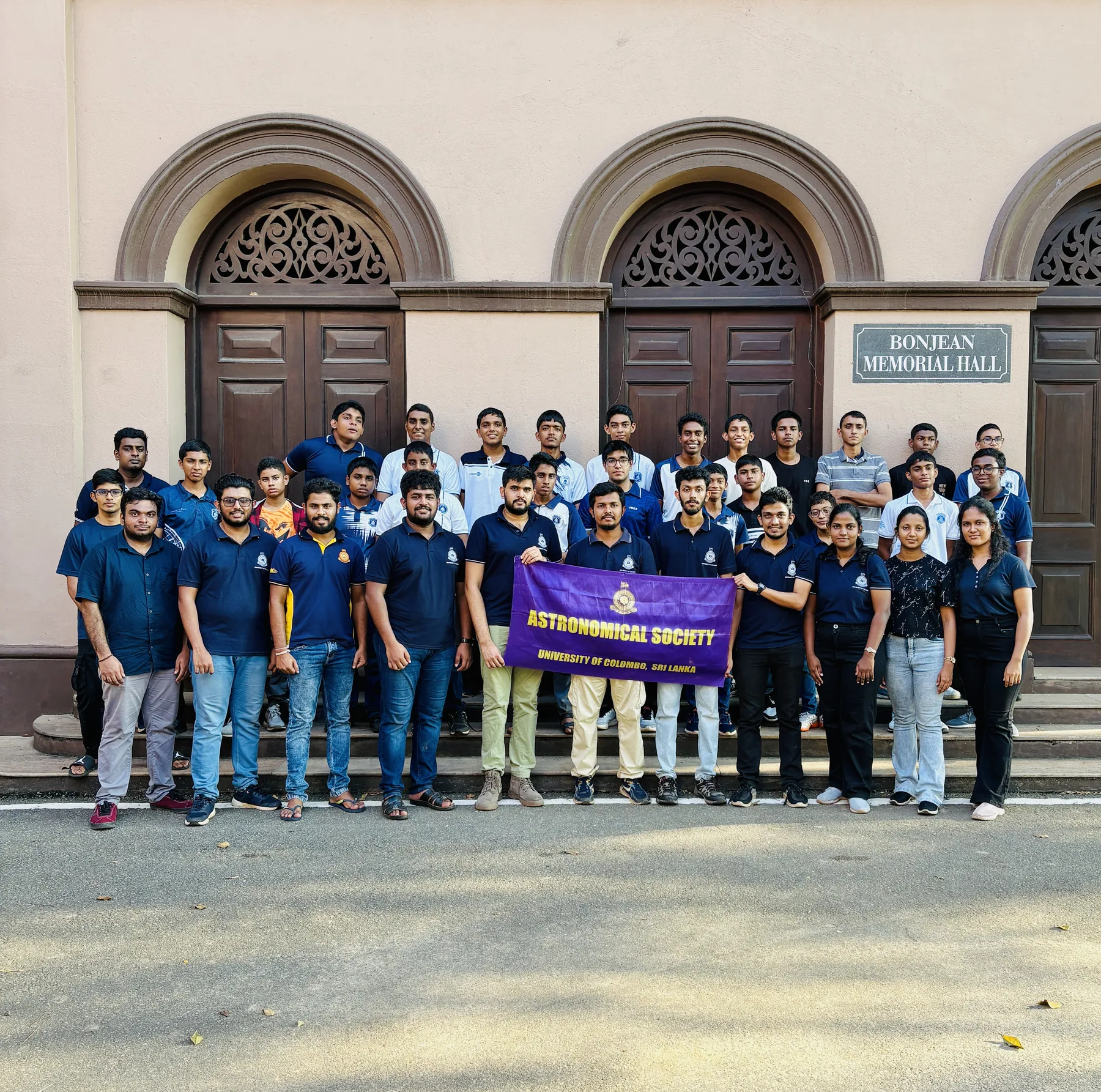 University astronomy society members gathered outside a faculty building