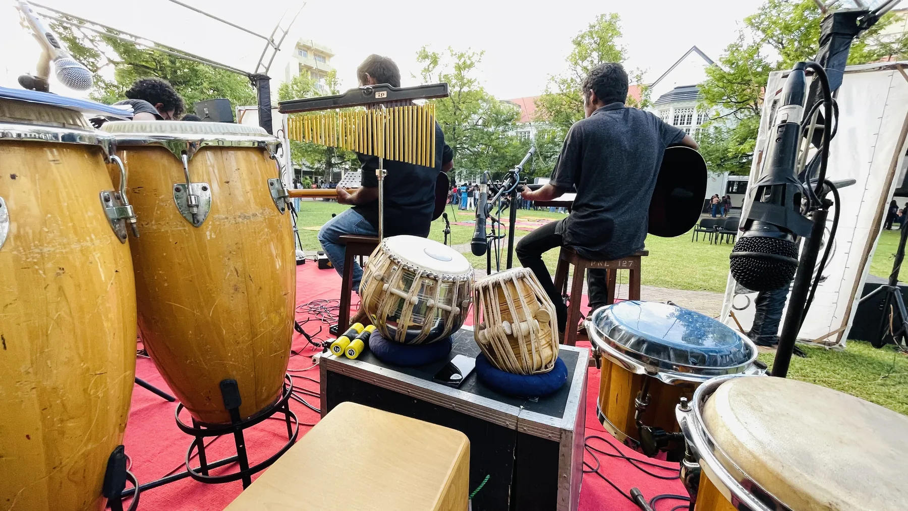 Percussion instruments and musicians arranged for an outdoor performance