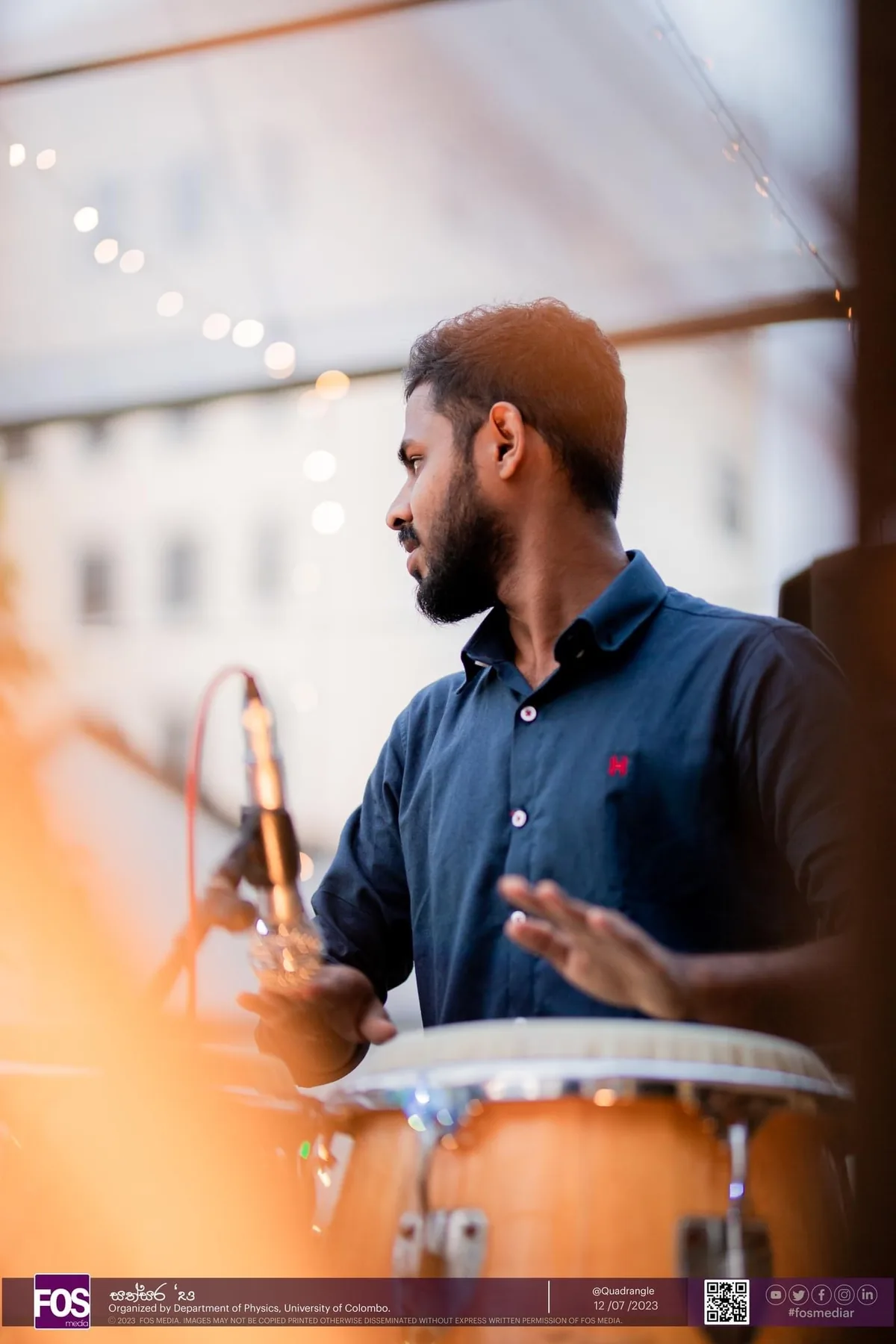 Sahan playing percussion during a live musical performance