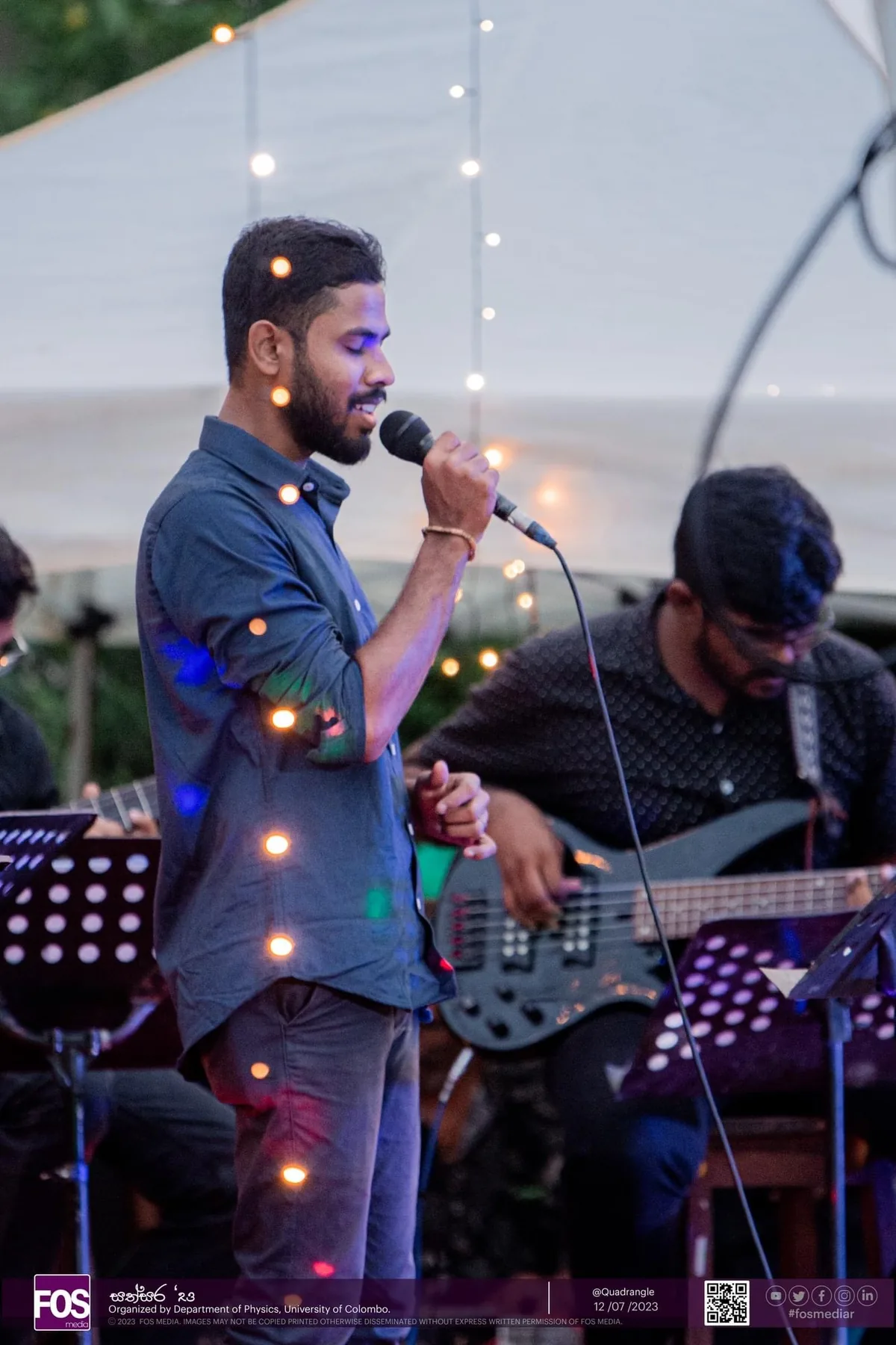 Sahan performing on stage with a musical ensemble