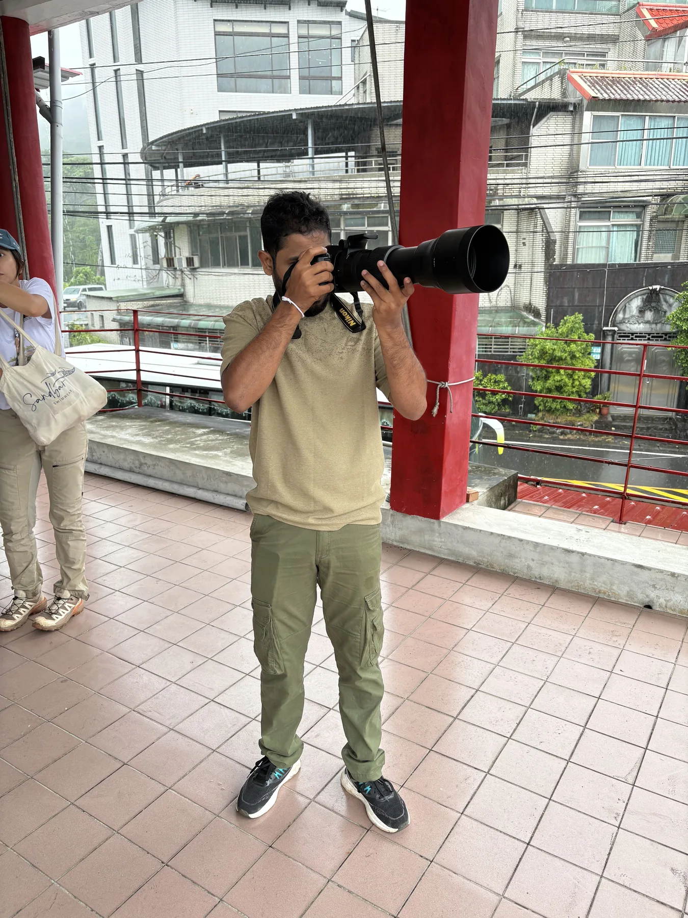 Sahan using a telephoto camera at an observation point