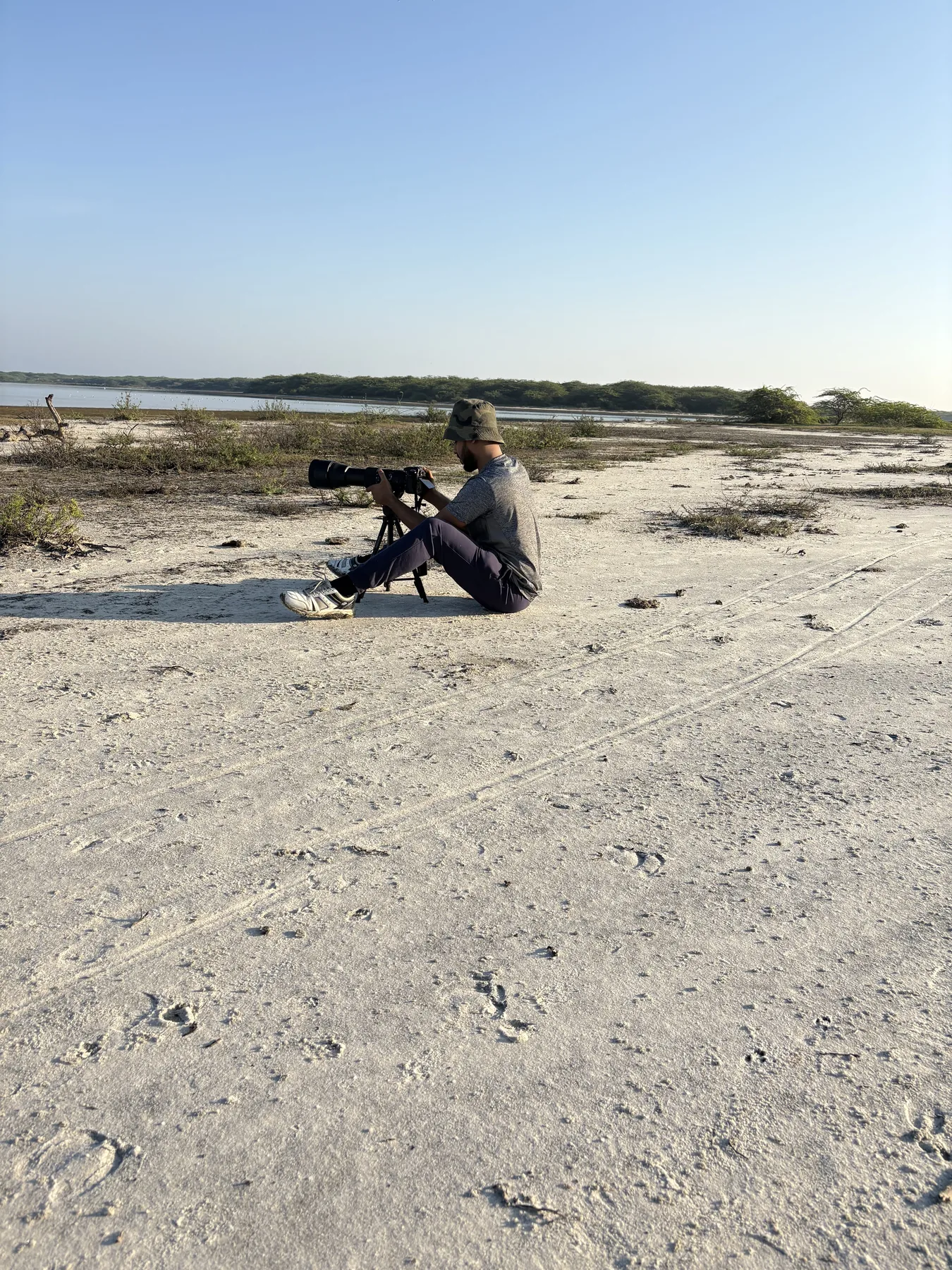 Sahan photographing from a shoreline observation position