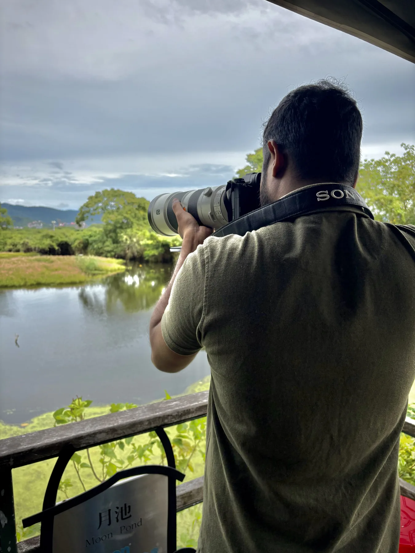 Sahan photographing wildlife from a wetland observation deck