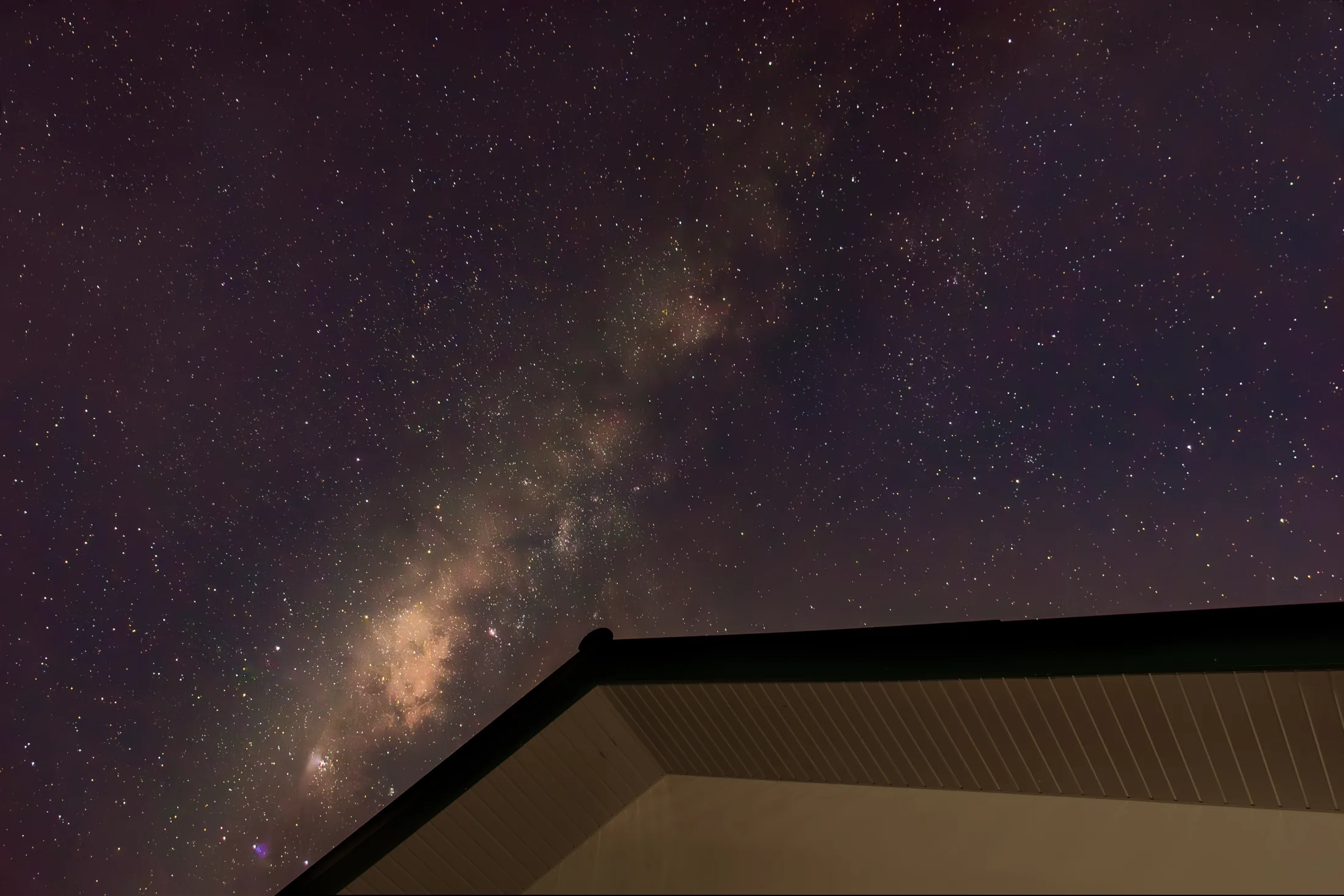 Milky Way rising above the angular edge of a rooftop