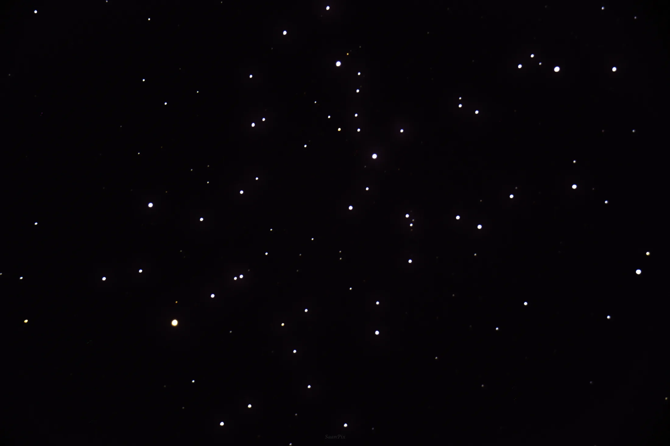 Bright open star cluster within a dark field of stars